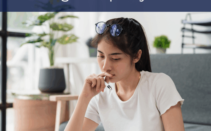 woman studying documents with laptop